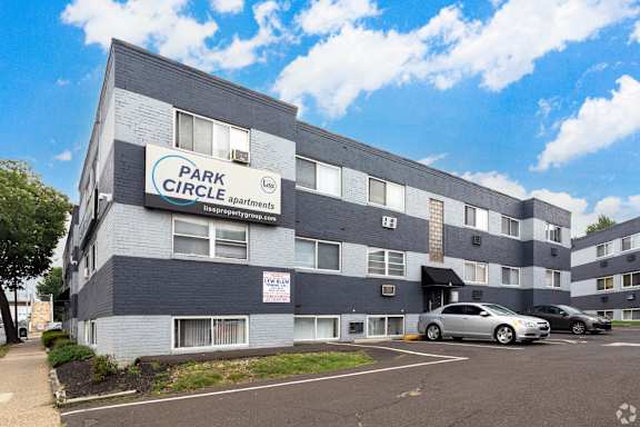 A multi-story building with a sign that reads "PARK CIRCLE apartments" is shown.