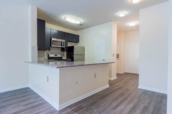 A kitchen area with a counter and cabinets.at Riverview Landing @ Valley Forge, Eagleville, PA 19403