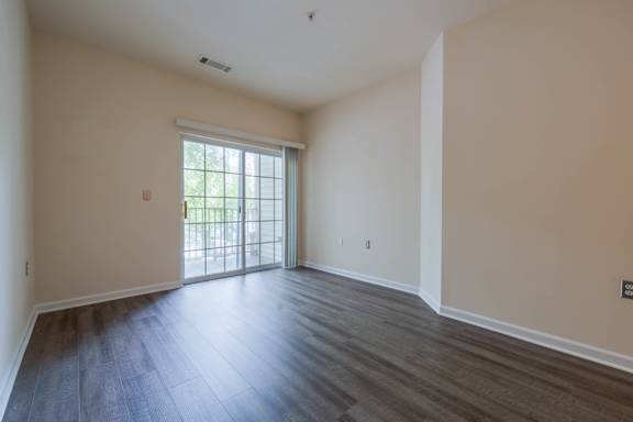 A room with a sliding glass door leading to a balcony.at Riverview Landing @ Valley Forge, Pennsylvania