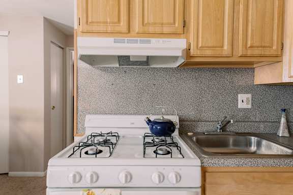 a kitchen with a stove and a sink at Grant Meadows Apartments, Pennsylvania