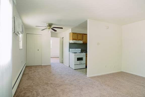 a empty room with a ceiling fan and a kitchen at Krewstown Park Apartments, Philadelphia, 19115