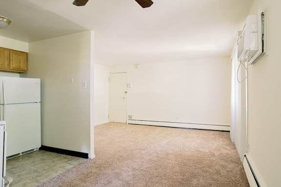 a kitchen with a white refrigerator and a white door at Krewstown Park Apartments, Philadelphia Pennsylvania