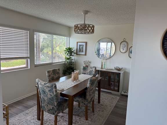 A dining room with a table and chairs.