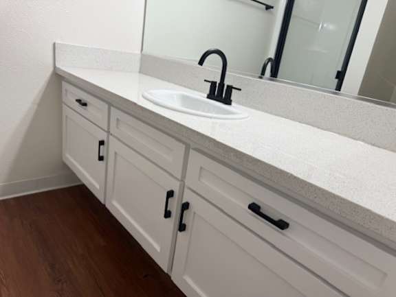 A bathroom with a sink and a mirror.