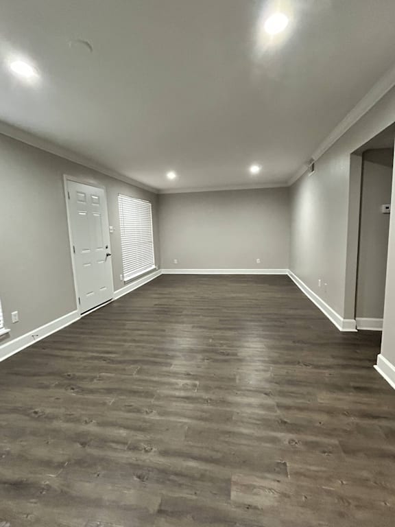A room with wooden flooring and white walls.