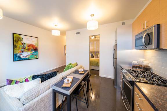 A kitchen with a stove top oven and a microwave above it.