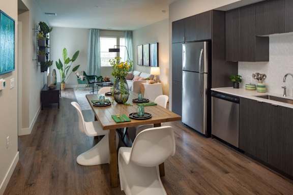 A modern kitchen with a dining table and chairs.