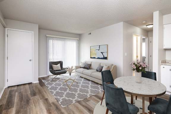 A living room with a grey rug and a white table.at Fish Creek, Iowa