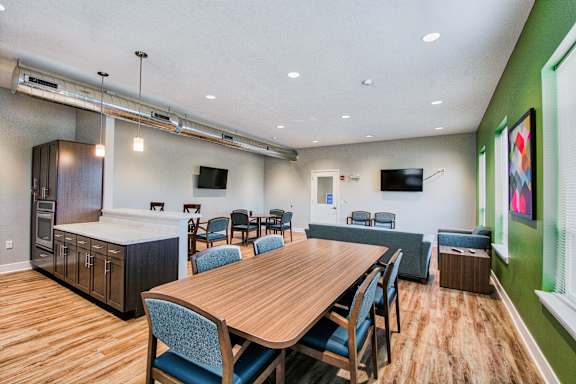 A conference room with a long table and chairs.