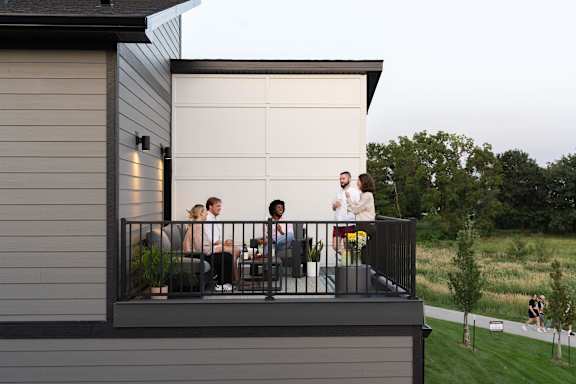 a group of people standing on a balcony at Rialto Townhomes Apartments, Waukee