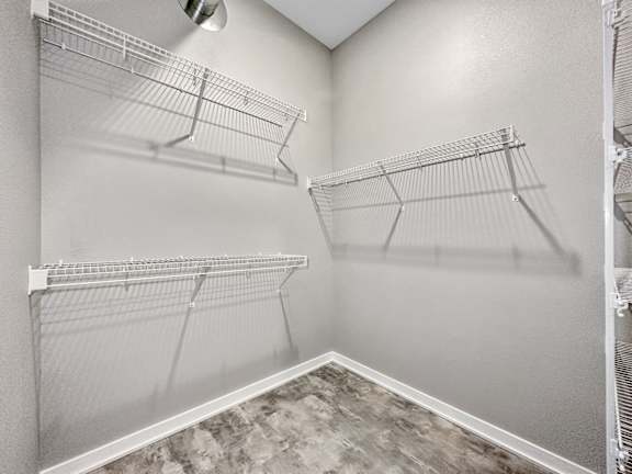 A walk-in closet with shelving and a fan.at Level, Des Moines, IA 50309