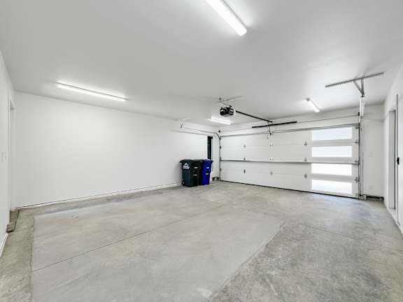 the interior of a garage with a white wall and a garage door  at Matilda 235 Townhomes, Des Moines, 50309
