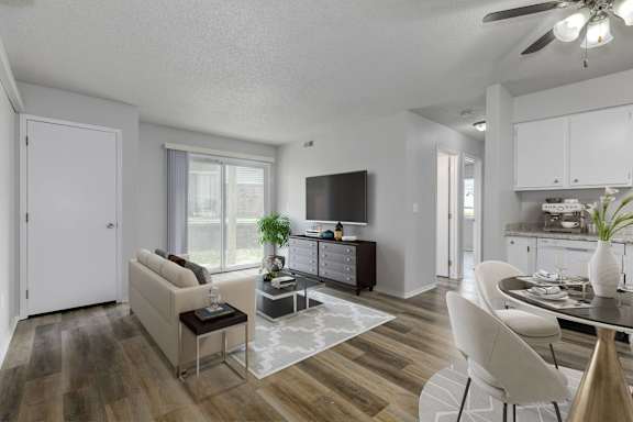 A modern living room with a white sofa and a glass coffee table.at Fish Creek, Norwalk