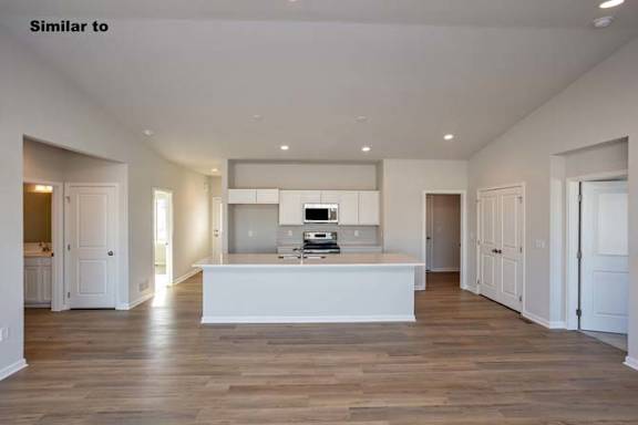 A spacious kitchen with a white island in the middle. at Two Rivers Home Rentals, West Des Moines, 50266