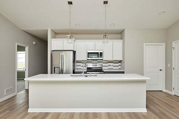 an empty kitchen with a white counter top at Two Rivers Home Rentals, Iowa 50266