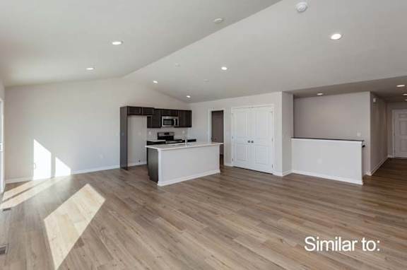 an empty living room and kitchen with a wooden floor at Two Rivers Home Rentals, Iowa