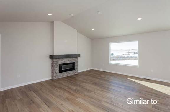 a living room with a fireplace and a wooden floor at Two Rivers Home Rentals, West Des Moines, IA
