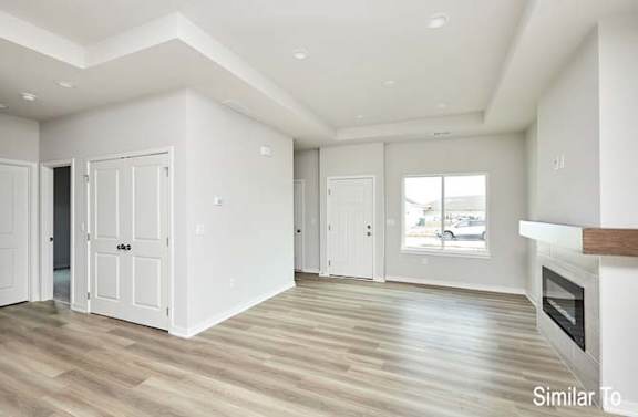an empty living room with white walls and a fireplace at Two Rivers Home Rentals, West Des Moines