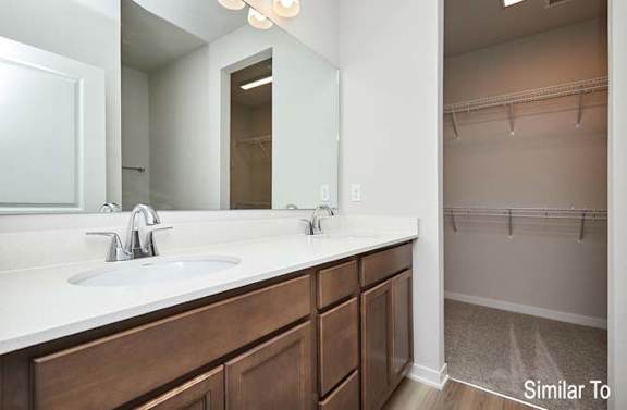 a bathroom with a sink and a mirror at Two Rivers Home Rentals, Iowa