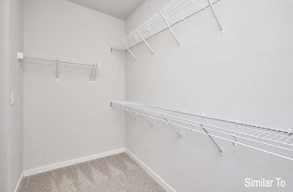 an empty closet with hanging racks on the wall at Two Rivers Home Rentals, Iowa
