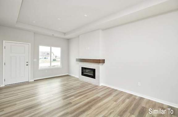 a empty living room with a fireplace and a door at Two Rivers Home Rentals, West Des Moines