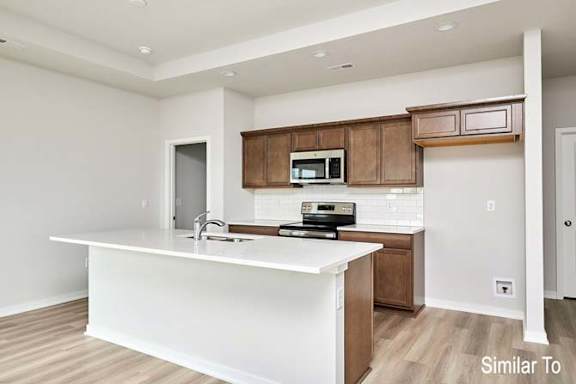 an empty kitchen with a large white counter top at Two Rivers Home Rentals, West Des Moines, IA 50266