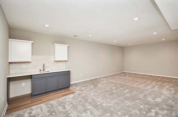 an empty living room with a sink and a kitchen at Two Rivers Home Rentals, West Des Moines, 50266