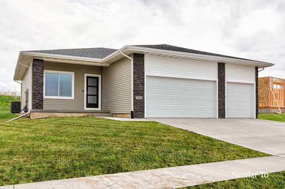 A two-car garage is attached to a house. at Two Rivers Home Rentals, West Des Moines, IA