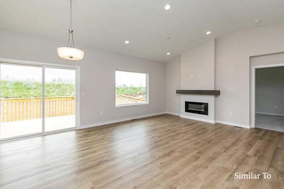 a empty living room with a fireplace at Two Rivers Home Rentals, Iowa