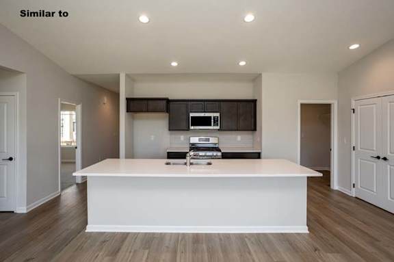 a large kitchen with a white counter top at Two Rivers Home Rentals, West Des Moines