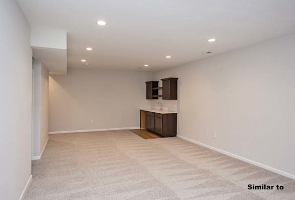 A room with a carpeted floor and a cabinet. at Two Rivers Home Rentals, West Des Moines, 50266