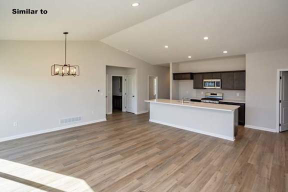 an empty kitchen and living room with a large at Two Rivers Home Rentals, West Des Moines, IA 50266