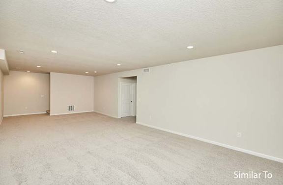 an empty living room with white walls and a door at Two Rivers Home Rentals, West Des Moines, IA 50266