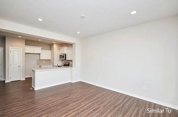 an empty living room with a kitchen and a at Two Rivers Home Rentals, Iowa