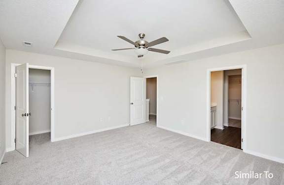 an empty living room with a ceiling fan at Two Rivers Home Rentals, Iowa