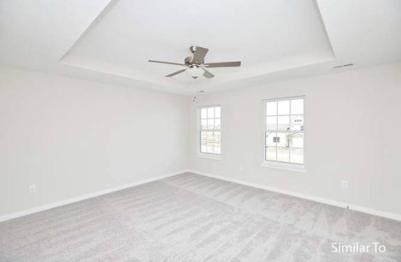 an empty room with a ceiling fan and a window at Two Rivers Home Rentals, West Des Moines, IA