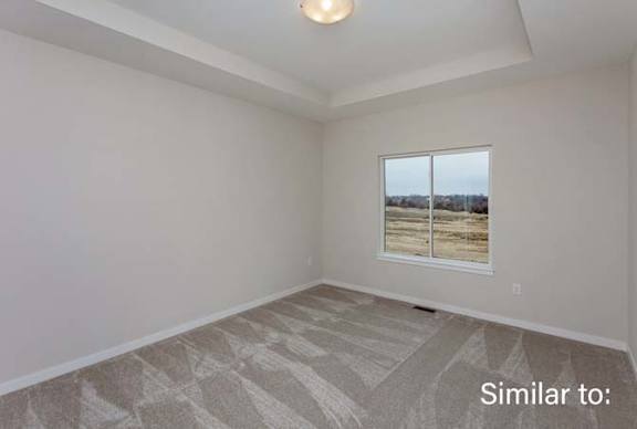 an empty living room with a window and at Two Rivers Home Rentals, West Des Moines