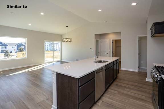 a large kitchen with a sink and a counter top at Two Rivers Home Rentals, West Des Moines, 50266