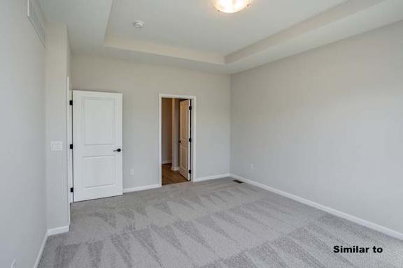 a empty living room with a door to a hallway at Two Rivers Home Rentals, West Des Moines, Iowa