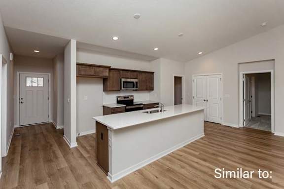 an empty kitchen with a large white counter top at Two Rivers Home Rentals, West Des Moines, IA