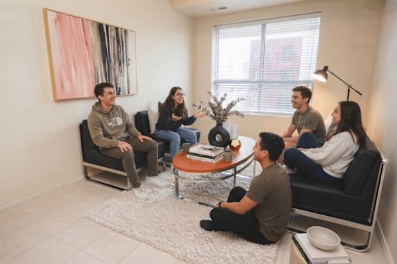 A group of people sitting in a circle in a room.