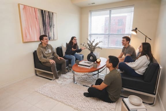 A group of people sitting in a circle in a room.