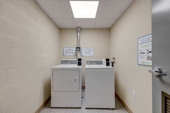 Two white copiers are in a small room.