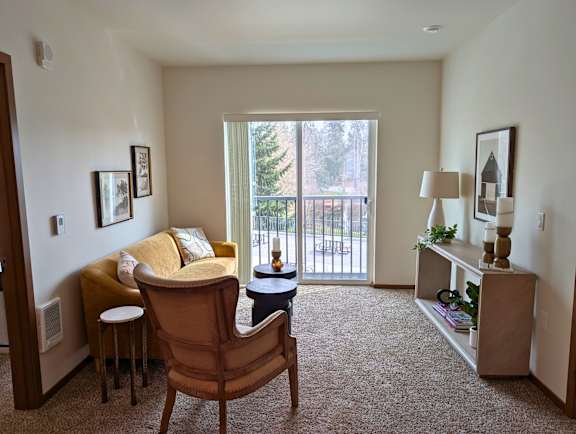Living room seating area in a model apartment at Ovation at Paine Field