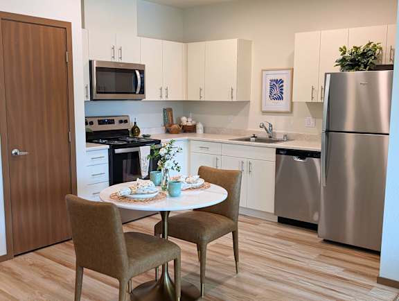 Modern kitchen and dining nook in a model apartment at Ovation at Paine Field