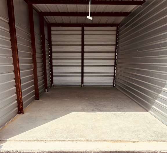 the inside of a parking garage with roll up doors