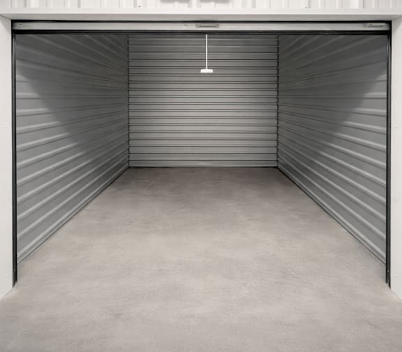A closed metal garage door with a hanger in the middle.
