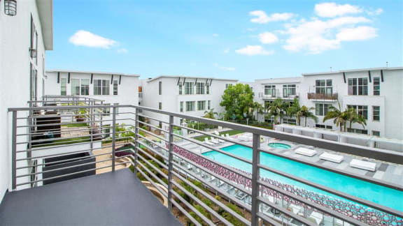 a view of a pool from a balcony of a building