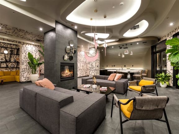 a living room with couches and chairs and a fireplace