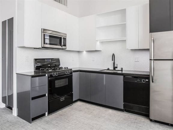 a kitchen with stainless steel appliances and a microwave